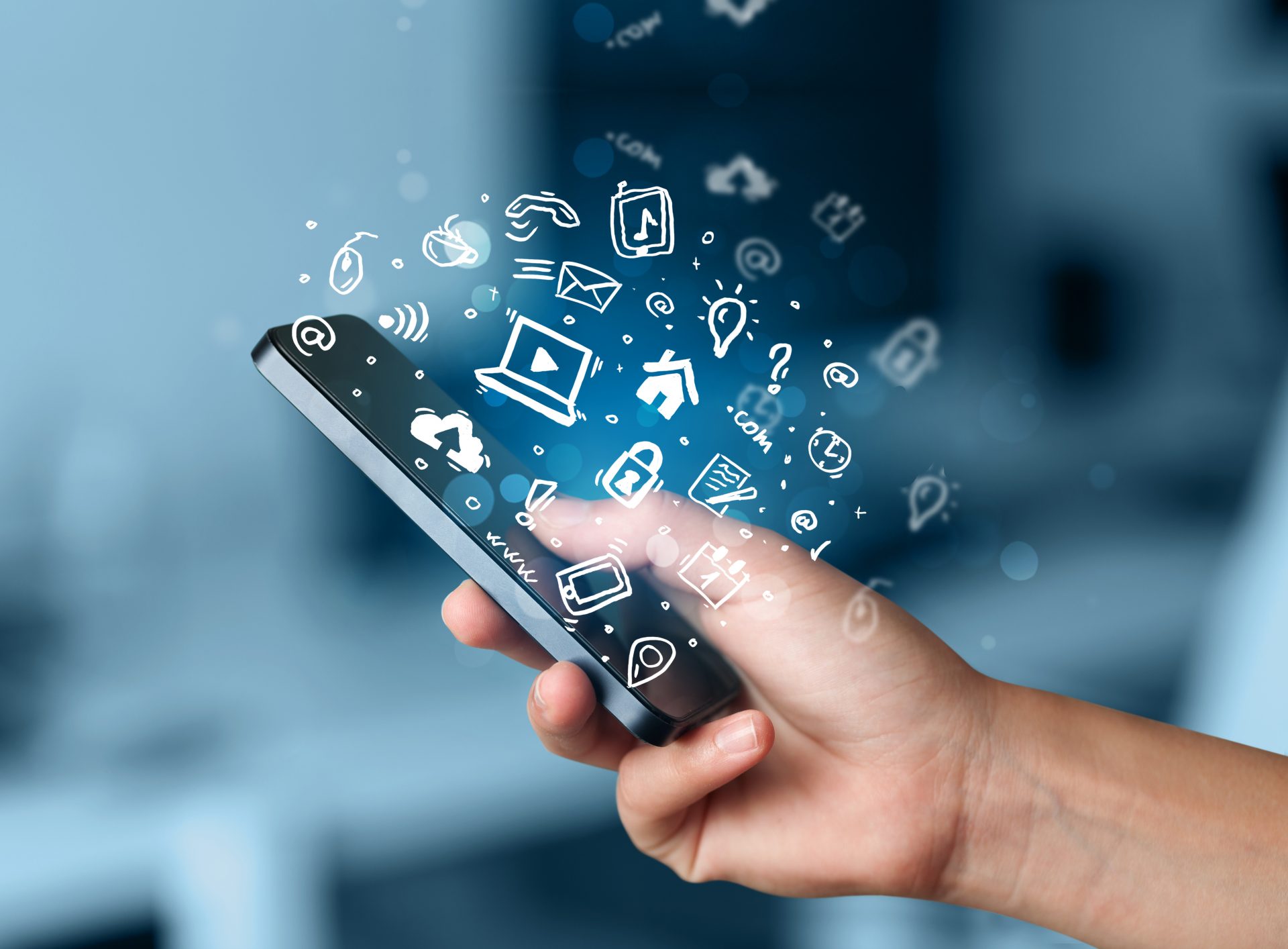 Hand holding smartphone with media icons and symbol